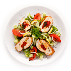 Salad with stuffed chicken fillet on white background