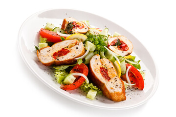 Salad with stuffed chicken fillet on white background