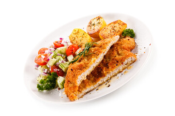 Fried pork chop with tomatoes and vegetable salad on white background
