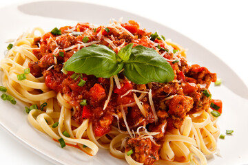 Pasta with bolognese sauce on white background