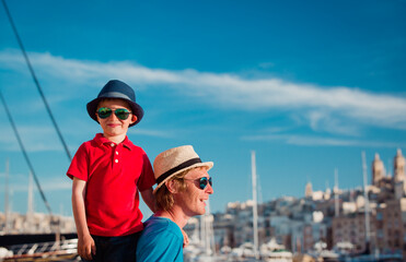 Obraz premium family travel - father and son playing on the quay of Malta
