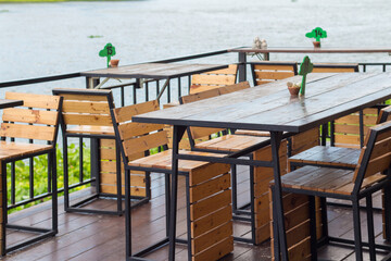 Dining table in the Cozy outdoor cafe. Dining table beside the river cafe.