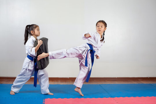 Two little girls demonstrate martial arts working together