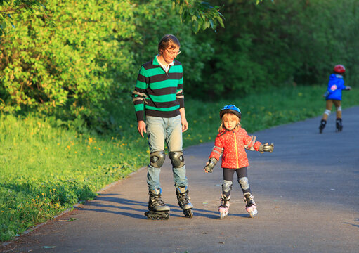 father teaching kids to roller skate, family sport