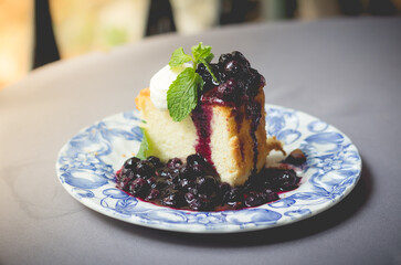 Blueberry cake with blueberry sauce. homemade blueberry cake with whipped cream