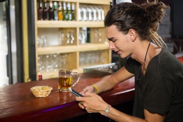 Man using mobile phone at counter