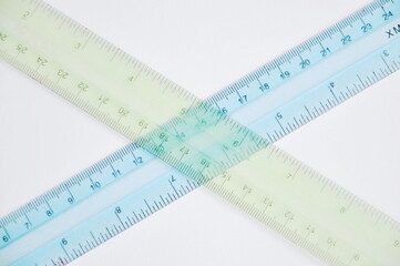 colorful plastic ruler crossing on white background