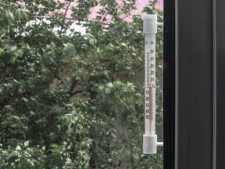 The thermometer on the window. Rain