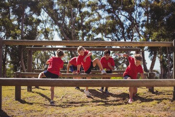 Kids jumping over the hurdles during obstacle course training