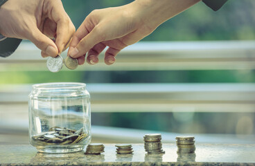 The couple's hands together to save money for the future to stand together. Future planning concepts