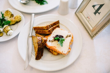 White plate with toasts stands before frame with number four