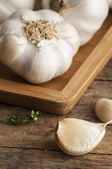 Garlic cloves on wooden vintage background.