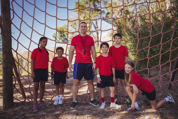 Trainer and kids standing together in the boot camp