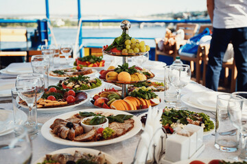 Large dishes with delicious food stand on table