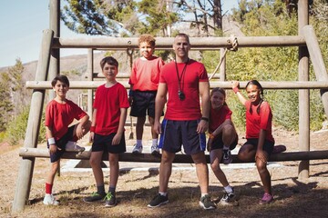 Trainer and kids standing together in the boot camp