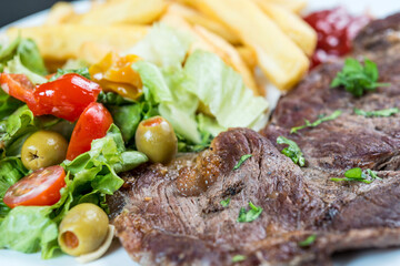 Fototapeta na wymiar juicy steak beef meat with tomato and french fries