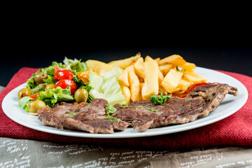 juicy steak beef meat with tomato and french fries
