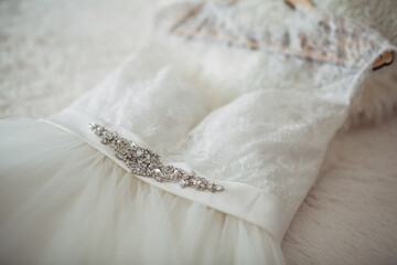 Wedding dress with crystals lies on the bed