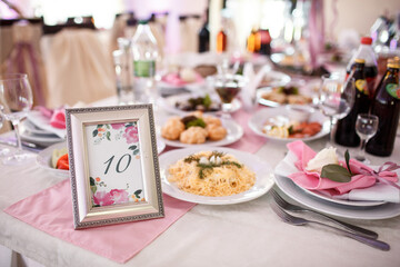 Frame with number ten stands on the dinner table