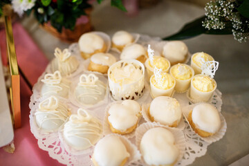 Cookies covered with white chocolate stand on a glass dish