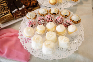 Cookies covered with white chocolate stand on a glass dish
