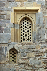 Arched windows in stone wall of an old mosque, Baku, Azerbaijan