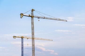 Two cranes , blue sky background 