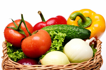 fresh vegetables concept, lettuce, tomatoes, onions, peppers, cucumber in basket