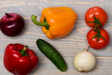 vegetables, tomatoes with onions, peppers, cucumber on blue vintage wooden