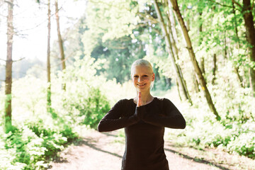 Fototapeta premium Woman doing yoga in forest