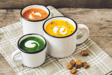 Homemade vegetarian soup made from fresh spinach pumpkin  tomatoes poured into a white mug