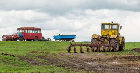 The tractor plows the land in the fields in the spring