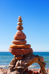 Fototapeta na wymiar Balance and poise stones. Rock zen on the background of blue sky and sea