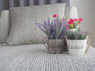 modern vintage sofa and fresh beautiful variety flower on vase at living room.