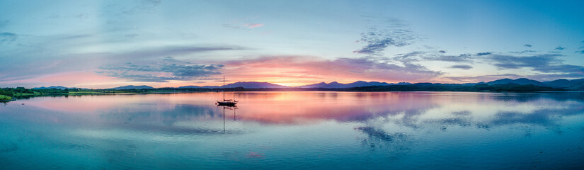 Aerial of an amazing sunset with sailing vessel Loch Creran, Barcaldine, Argyll - obrazy, fototapety, plakaty