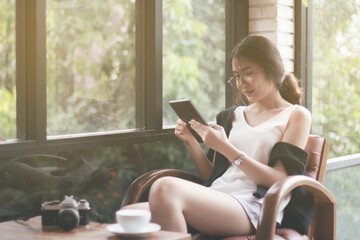Young Woman Drinking Coffee And Using Tablet Computer In Cafe.internet Of Things Concept.