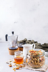 Breakfast with black coffee muesli granola honey nuts milk