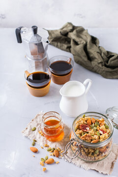 Breakfast with black coffee muesli granola honey nuts milk