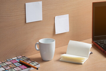 Notebook with drawings and cup of coffee on wooden table. Creative concept.