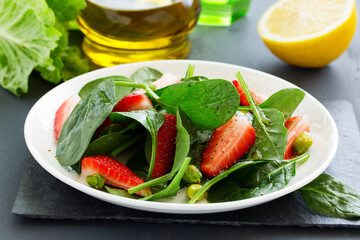 Dietary salad with strawberries and spinach.