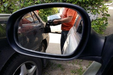 auto mechanic pours gasoline from the canister into the machine.