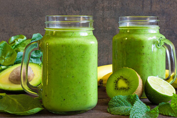 healthy drink. green smoothie with banana, spinach, avocado, kiwi, mint and chia seeds