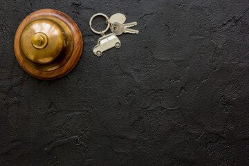 booking hotel room, ring and keys dark desk background top view mock up