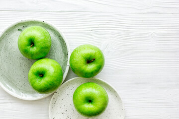Healthy green food with apples on plates white background top view mock up