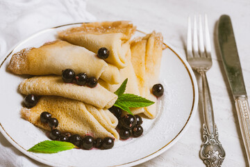 Homemade pancakes with honey, jam and berries with powder sugar
