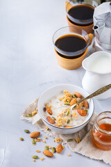 Breakfast with black coffee muesli granola honey nuts milk