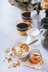 Breakfast with black coffee muesli granola honey nuts milk