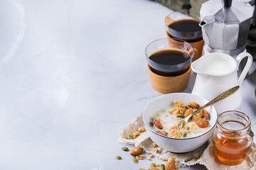 Breakfast with black coffee muesli granola honey nuts milk