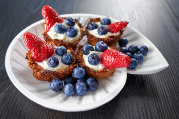 Mascarpone cookie with blueberry and strawberry on a plate