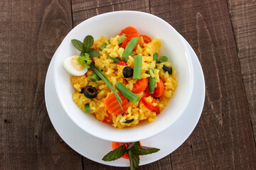 Boiled rice in water with turmeric